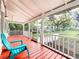 Screened porch with red flooring and a view of the backyard at 210 15Th E St, Bradenton, FL 34208