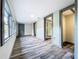 Long hallway with wood-look floors and multiple doors at 210 15Th E St, Bradenton, FL 34208