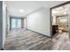 Spacious hallway with wood-look flooring and access to bathroom and backyard at 210 15Th E St, Bradenton, FL 34208