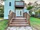 Two story light blue house with deck and backyard at 210 15Th E St, Bradenton, FL 34208
