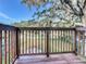Wooden deck overlooking backyard with tree and neighborhood views at 210 15Th E St, Bradenton, FL 34208