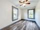 Well-lit bedroom with wood-look floors and two windows at 210 15Th E St, Bradenton, FL 34208