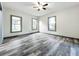 Spacious living room with wood-look flooring and ceiling fan at 210 15Th E St, Bradenton, FL 34208