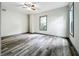 Bright bedroom with wood-look floors, large window, and ceiling fan at 210 15Th E St, Bradenton, FL 34208