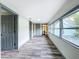 Long hallway with wood-look floors and doors to bedrooms at 210 15Th E St, Bradenton, FL 34208