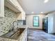Modern kitchen with white cabinets and granite countertops at 210 15Th E St, Bradenton, FL 34208