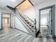 Interior view of a staircase with grey railing and wood flooring at 210 15Th E St, Bradenton, FL 34208