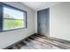Simple bedroom with wood-look floors and exterior access at 210 15Th E St, Bradenton, FL 34208