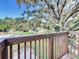 Wooden deck overlooking backyard with tree and neighborhood views at 210 15Th E St, Bradenton, FL 34208