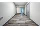 Long hallway with wood-look floors, leading to bedrooms at 210 15Th E St, Bradenton, FL 34208