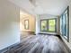 Bright living room with grey wood-look floors and multiple windows at 210 15Th E St, Bradenton, FL 34208