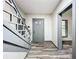 Inviting entryway with gray staircase and wood-look floors at 210 15Th E St, Bradenton, FL 34208