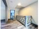 Upstairs hallway with grey wood-look floors and a unique railing at 210 15Th E St, Bradenton, FL 34208