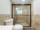 Walk-in shower with pebble floor and glass enclosure at 210 15Th E St, Bradenton, FL 34208