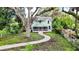 Two-story light teal home with a wrap around porch at 210 15Th E St, Bradenton, FL 34208