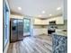 Modern kitchen with white cabinets, granite counters, and stainless steel appliances at 210 15Th E St, Bradenton, FL 34208