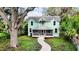 Two-story light teal home with a wrap around porch at 210 15Th E St, Bradenton, FL 34208