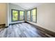 Cozy bedroom featuring three windows and gray flooring at 210 15Th E St, Bradenton, FL 34208
