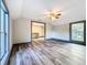 Spacious bedroom with wood-look floors, ceiling fan and window at 210 15Th E St, Bradenton, FL 34208
