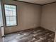 Bright bedroom featuring wood-look flooring and ample natural light at 1386 Ibis Dr, Englewood, FL 34224