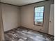 Spacious bedroom with wood-look flooring and a large window at 1386 Ibis Dr, Englewood, FL 34224