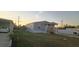 Side view of a single-story home with a driveway and fenced backyard at 1386 Ibis Dr, Englewood, FL 34224