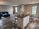 Open-concept living area with a comfortable seating area, dining table, and kitchen island at 1386 Ibis Dr, Englewood, FL 34224