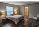 Relaxing main bedroom featuring a comfortable bed, ample lighting, and an attached bathroom at 1386 Ibis Dr, Englewood, FL 34224