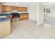 Kitchen features wood cabinets and a tiled floor at 229 Maple Ave, Palm Harbor, FL 34684