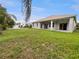 Large backyard with a covered patio, perfect for entertaining and enjoying outdoor living in a serene setting at 2302 123Rd E Pl, Parrish, FL 34219