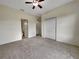 Bright bedroom featuring neutral walls, soft carpeting, and a ceiling fan, offering comfort and style at 2302 123Rd E Pl, Parrish, FL 34219