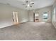 Spacious carpeted bedroom with ceiling fan and multiple windows at 2302 123Rd E Pl, Parrish, FL 34219