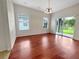Dining room features wood floors, windows, and a sliding door at 2302 123Rd E Pl, Parrish, FL 34219