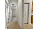 Neutral hallway features tiled floors and white trim throughout at 2302 123Rd E Pl, Parrish, FL 34219