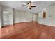 Spacious living room featuring hardwood floors, a ceiling fan, and an open layout, perfect for entertaining at 2302 123Rd E Pl, Parrish, FL 34219