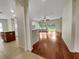 Open-concept living room featuring hardwood floors, a ceiling fan, and seamless access to the kitchen at 2302 123Rd E Pl, Parrish, FL 34219