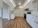 Bright kitchen with white cabinets, stainless steel appliances, and wood-look floors at 8188 San Jacinto Ave, North Port, FL 34287