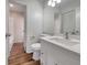 Updated bathroom with white vanity and wood-look flooring at 8188 San Jacinto Ave, North Port, FL 34287