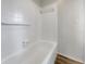 Clean bathroom featuring a white bathtub and tiled walls at 8188 San Jacinto Ave, North Port, FL 34287