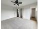 Spacious bedroom with carpet flooring, ceiling fan, and walk-in closet at 8188 San Jacinto Ave, North Port, FL 34287