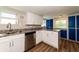 Modern kitchen with white cabinets, granite countertops, and stainless steel appliances at 580 Leach St, Englewood, FL 34223
