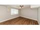Bright bedroom with ceiling fan and wood-look floors at 580 Leach St, Englewood, FL 34223