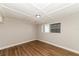 Simple bedroom with wood-look flooring and a window at 580 Leach St, Englewood, FL 34223