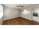 Bright bedroom with wood-look floors and exterior access at 580 Leach St, Englewood, FL 34223