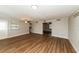 Spacious living room with light wood laminate flooring and ceiling fan at 580 Leach St, Englewood, FL 34223
