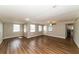 Open living room with wood-look floors and access to the kitchen at 580 Leach St, Englewood, FL 34223