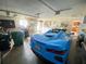 Garage with a blue Corvette and storage shelves at 156 Francis Ne Dr, Port Charlotte, FL 33952