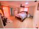 Bedroom with double bed and orange curtains at 156 Francis Ne Dr, Port Charlotte, FL 33952