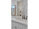 Stylish bathroom vanity with a marble countertop, framed art, and modern fixtures at 1529 Rio Vista Ter, Parrish, FL 34219