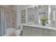 Well-lit bathroom with a shower-tub combo, elegant fixtures, and soft gray cabinetry at 1529 Rio Vista Ter, Parrish, FL 34219
